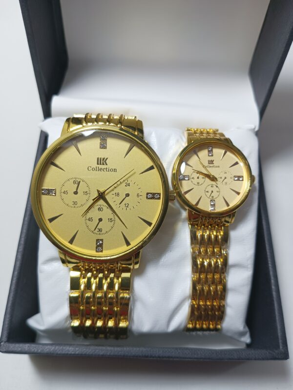 Two golden couple watches elegantly displayed in a box against a pristine white background.