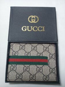Classic Gucci wallet in black box with red, green, and white stripes.