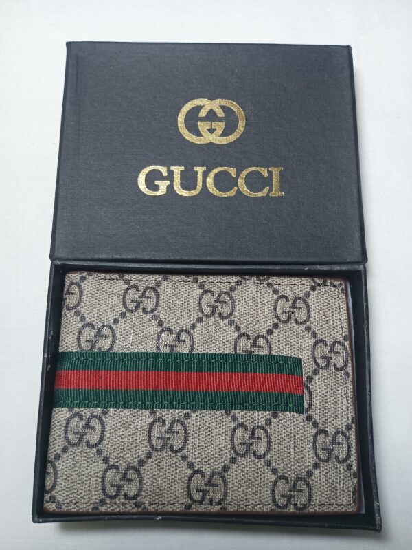 Classic Gucci wallet in black box with red, green, and white stripes.