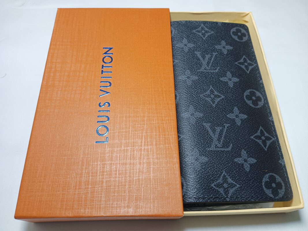 A Louis Vuitton wallet in an orange box, showcasing luxury and style.