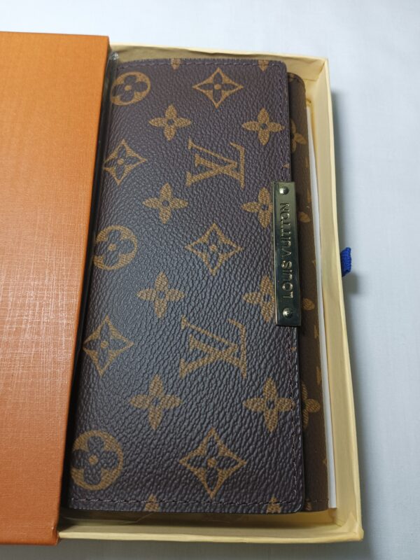 Louis Vuitton notebook in box: A stylish and luxurious notebook by Louis Vuitton, neatly packaged in a box.