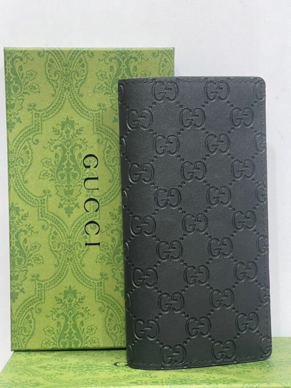 Gucci leather wallet with green box: A stylish wallet made of leather by Gucci, accompanied by a green box.
